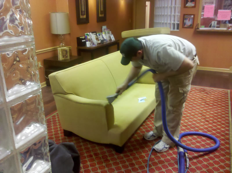PROFESSIONAL CLEANER REMOVING STAINS FROM CARPET AND UPHOLSTERY